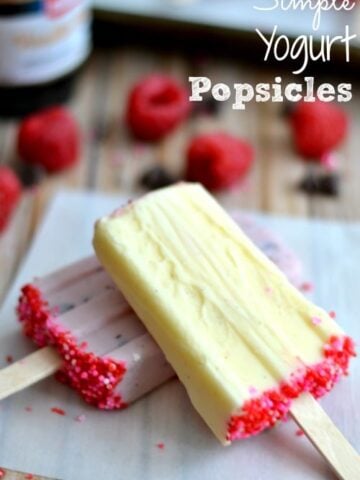 yellow and pink yogurt popsicles with hot pink sprinkles on the the bottoms