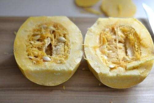 spaghetti squash cut in half on a cutting board