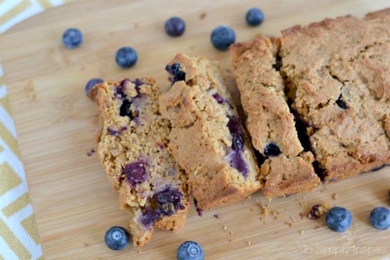 several slices of blueberry bread on a wood cutting board