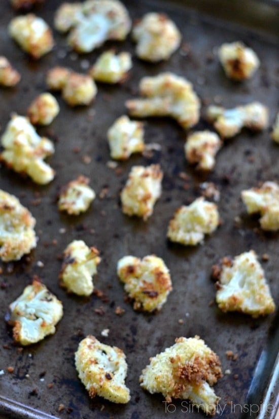 A close up of Cauliflower florets on a baking pan