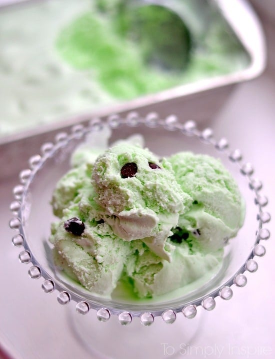 mint chocolate chip ice cream scoops in a glass bowl