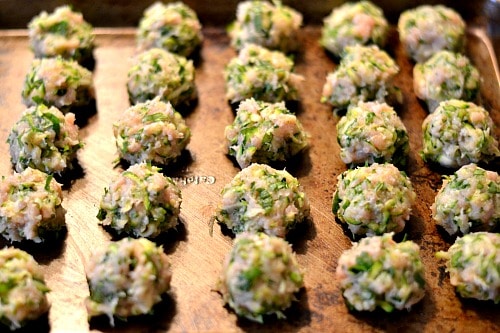 turkey zucchini meatball poppers on a baking sheet