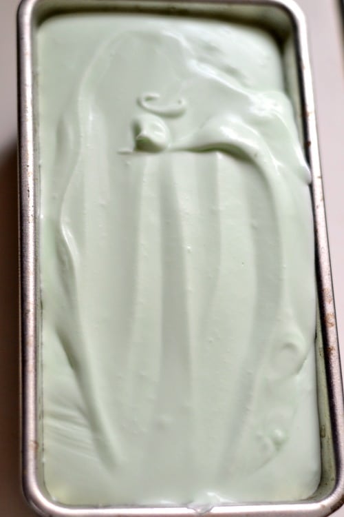 A close up of loaf pan with light green ice cream