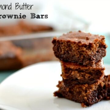 a stack of three brownies on a white plate