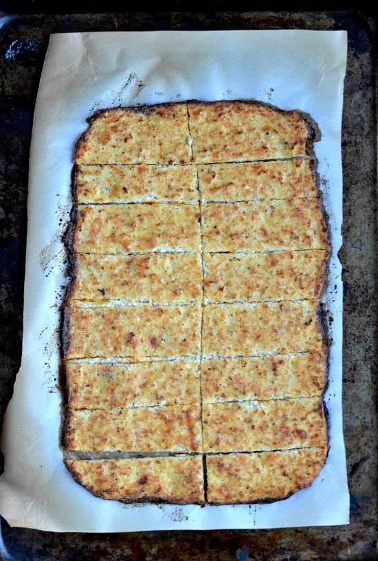 slices of Cauliflower Cheesy Bread on a baking sheet.