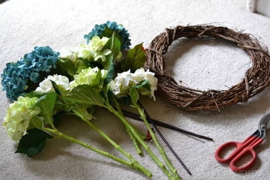 grapevine wreath and hydrangea flower stems on floor