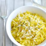 spaghetti squash topped with parmesan cheese in a white bowl