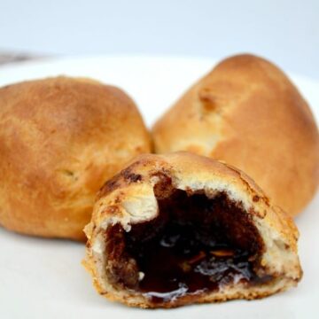 A plate with a crescent roll filled with cinnamon sugar