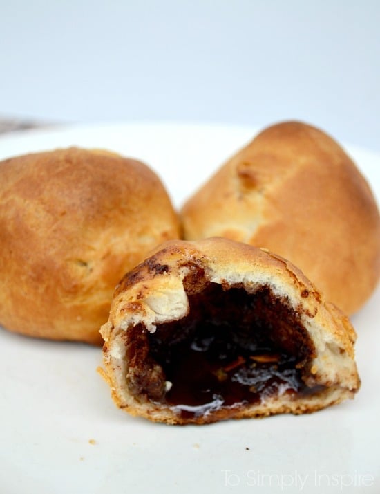 A plate with a crescent roll filled with cinnamon sugar
