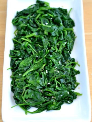 Sauteed Spinach with garlic on a white plate
