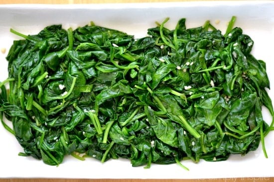 Sauteed Spinach with garlic piled on a white plate