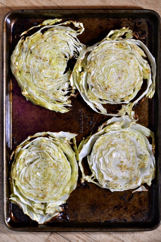 Baked cabbage slices on a baking sheet