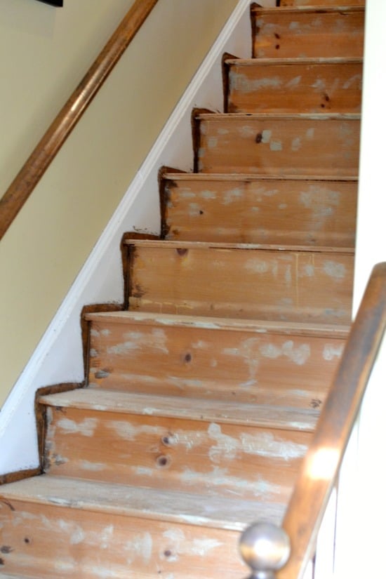 A wood staircase with no carpet