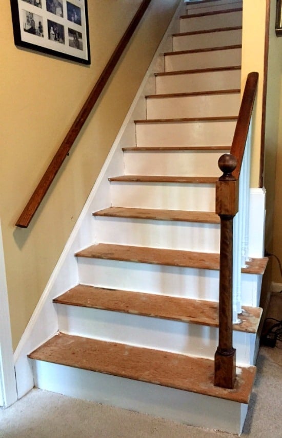 A wood staircase with risers being painted white