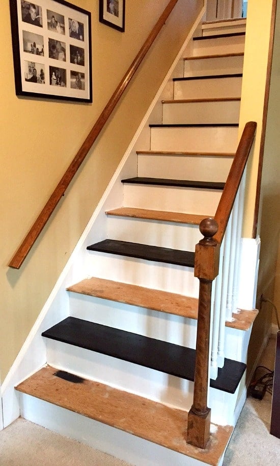 a wood staircase with steps being painted black