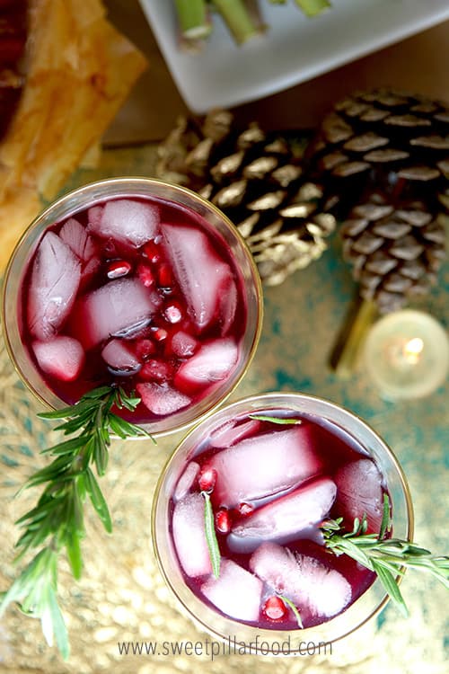 A close up of Pomegranate rosemary water with ice