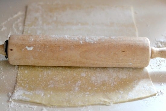 Rolling puffed pastry sheets with a rolling pin