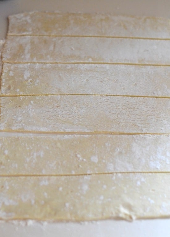 Sliced puffed pastry sheets on a counter