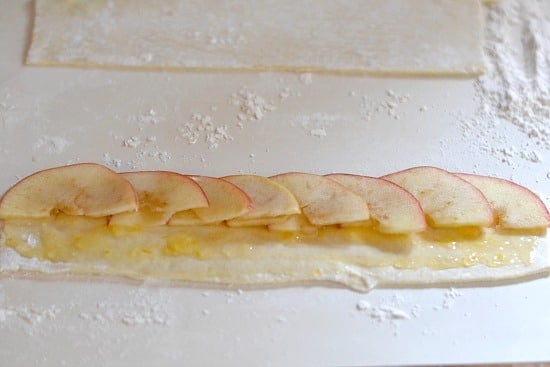 Sliced apples on puffed pastry sheets 