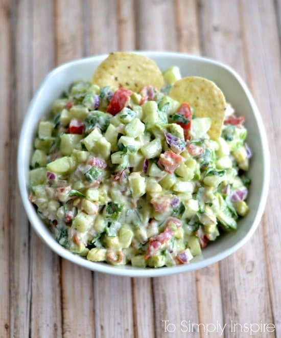 Mouthwatering yumminess with every bite, this fresh Cucumber Avocado Salsa will easily become one of your favorite appetizers. Cucumber Avocado Salsa recipe in a white bowl