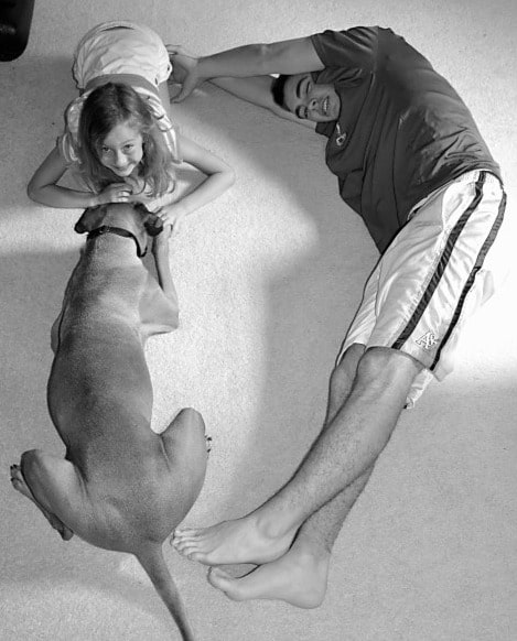 kids and their dog lying on the floor