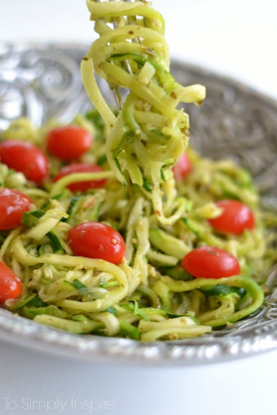 A plate of food, with Pesto, tomatoes and zucchini Noodles