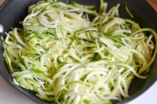 uncooked Zucchini Noodles in a black pan