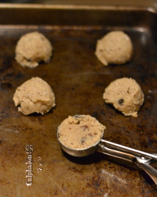 Oatmeal Chocolate Chip Cookie scoops on a cookie sheet.