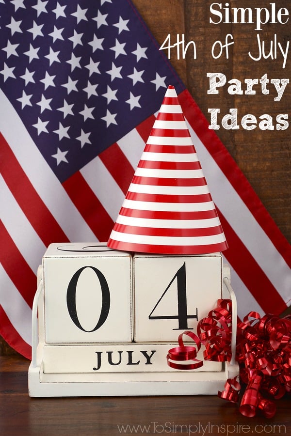 Cream colored wooden blocks with 0 and 4 on them and July underneath in front of an American flag