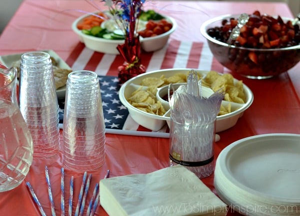 A table topped with plates of food with red white and blue theme