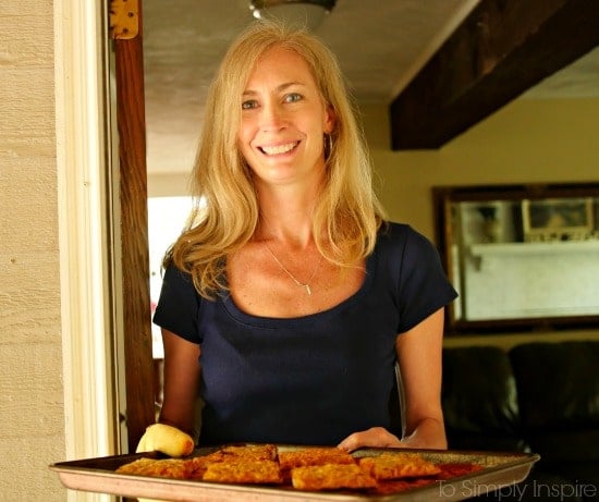 A woman standing in front of a tray of food