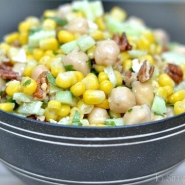 A gray bowl of Chickpea salad and corn