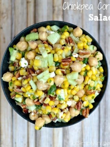 bowl full of chickpeas, corn, cucumber slices and pecans