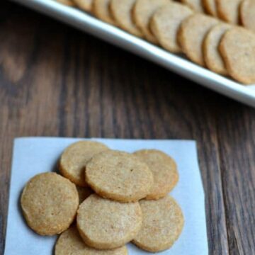 a bunch of cheese crackers on a white napkin