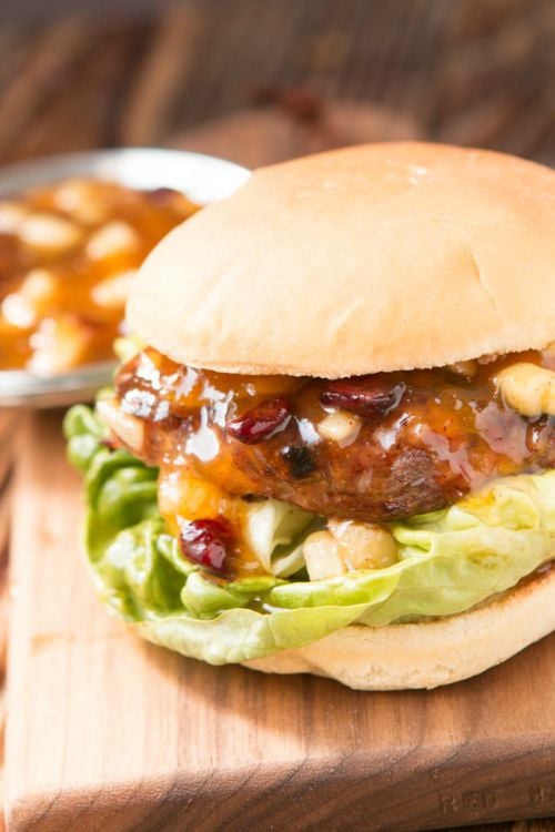 a turkey burger topped with sauce with lettuce