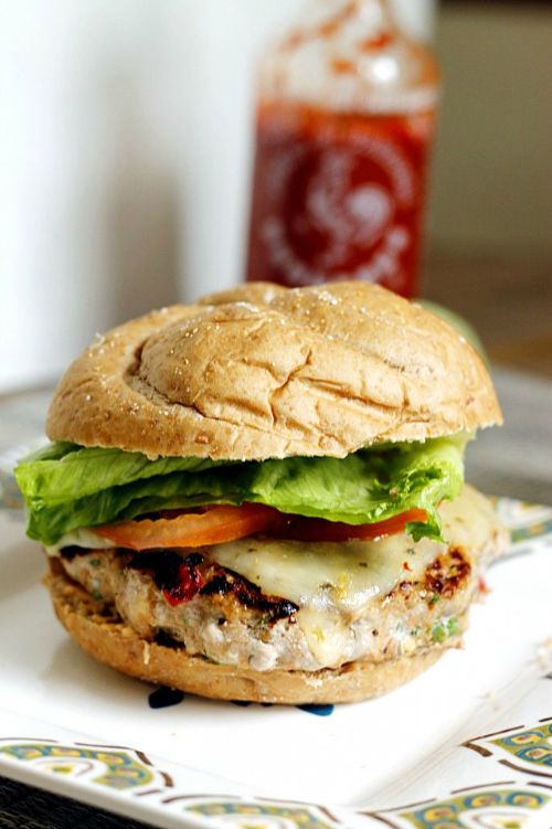 turkey burger topped with lettuce, tomato and cheese