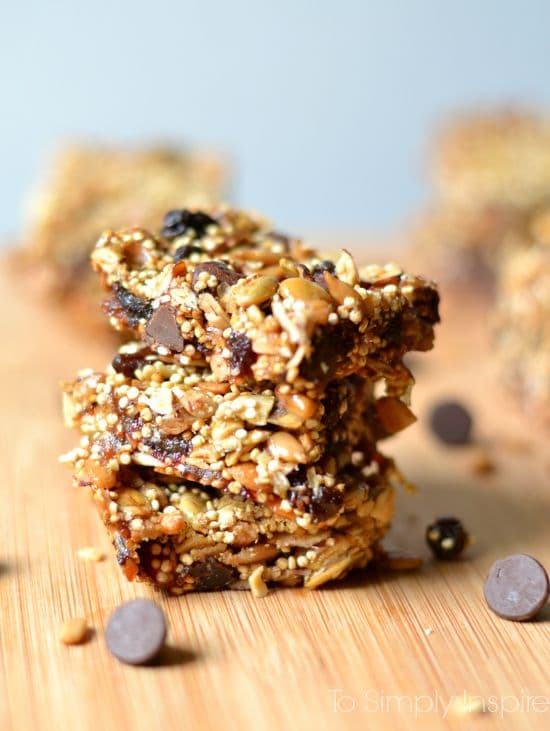 These yummy Energy Bars are packed full of superfood nutrients and sweetened with honey and just a little touch of chocolate. stack of 3 oat and quinoa energy bars with chocolate chips around
