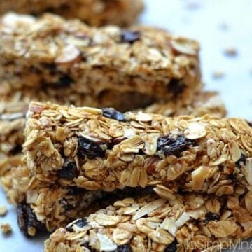 Granola bars with raisins stacked on a plate