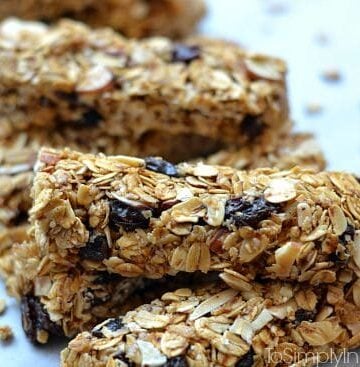 Granola bars with raisins stacked on a plate