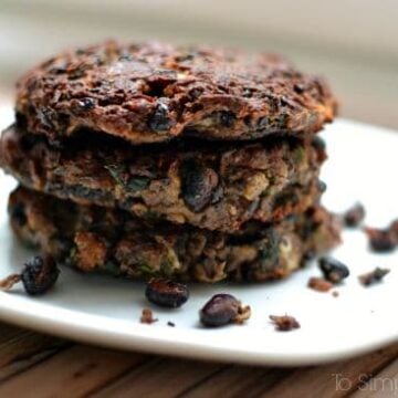 a stack of three black bean burgers on a white plate