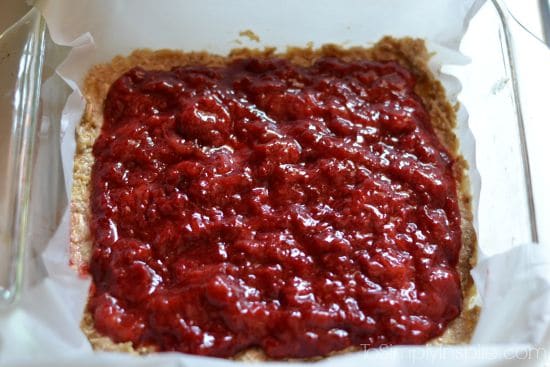 strawberry jam spread over oatmeal bars