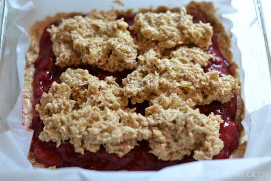 oatmeal banana mixture on top of strawberry jam in a square dish