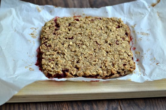 cooked strawberry oatmeal bars on parchment paper