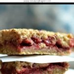 strawberry Banana Oatmeal Bars stacked with white parchment paper in between