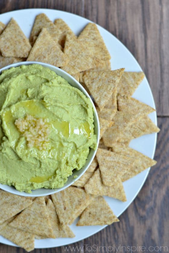 Avocado Hummus recipe on a plate surrounded with triscuit crackers.