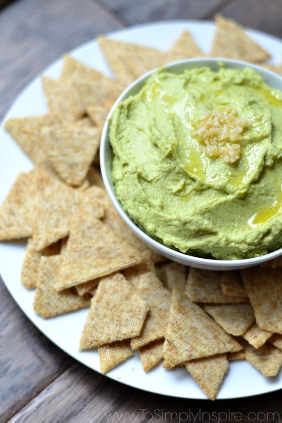 Avocado Hummus recipe on a plate with crackers.