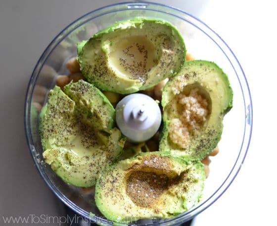 avocado halves and chickpeas in a food processor