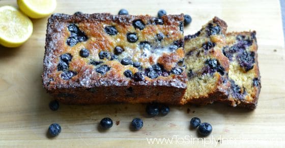 A close up of a piece of blueberry bread on a cutting board