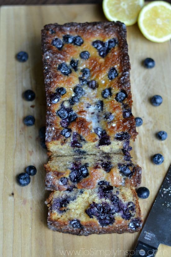 A close up of a piece of blueberry bread on a cutting board