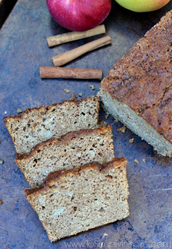 A close up of three slices of applesauce bread beside the loaf